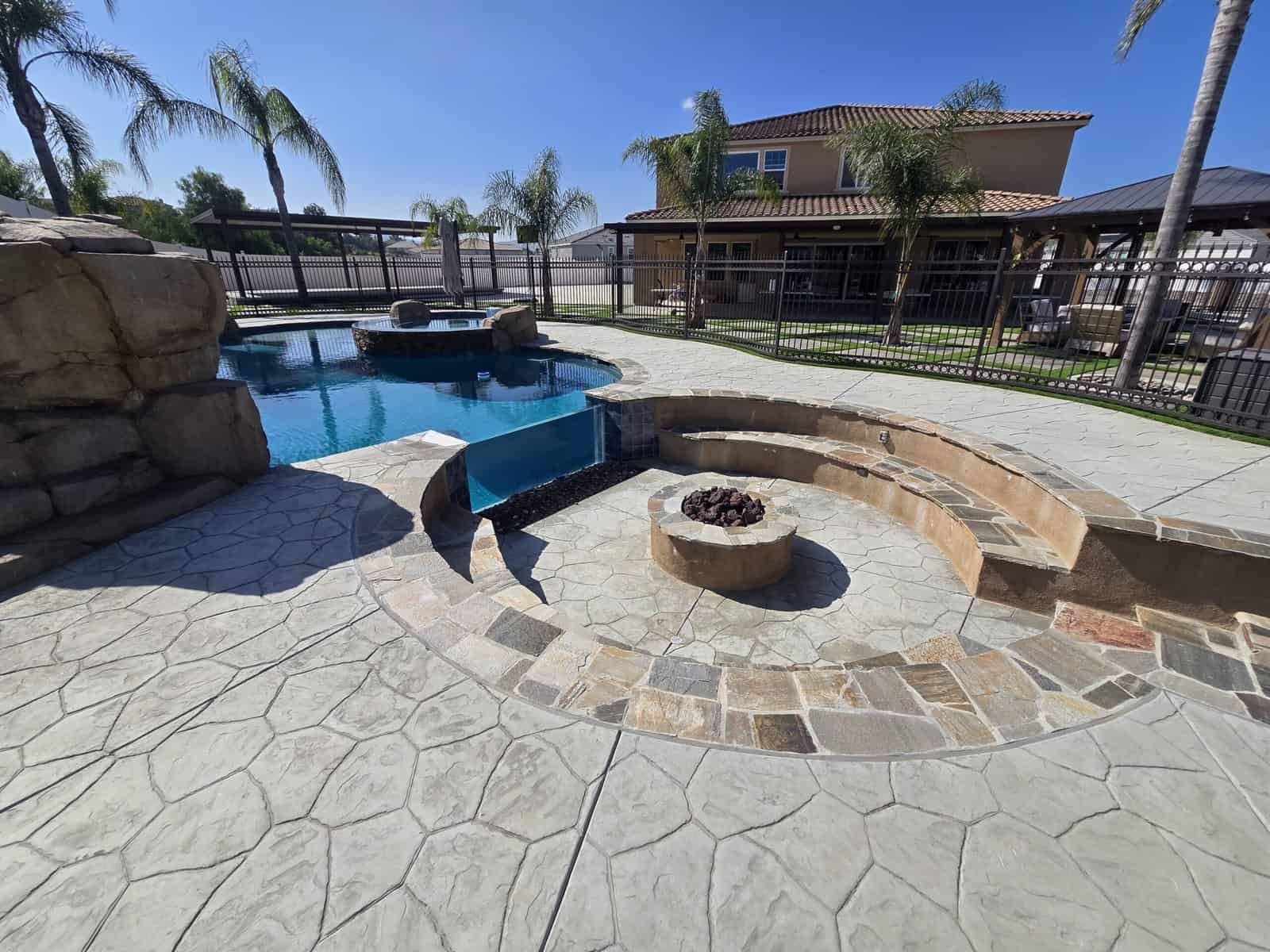 Pool and fire pit area in a modern backyard setting.