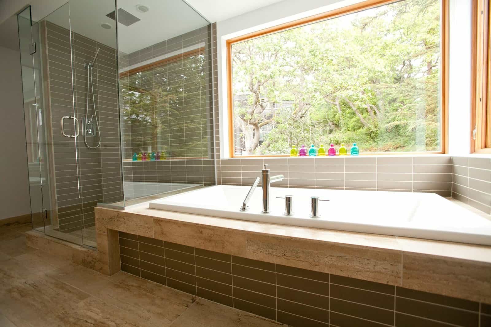 Spacious bathroom featuring a large bathtub and a separate glass-enclosed shower with modern fixture.